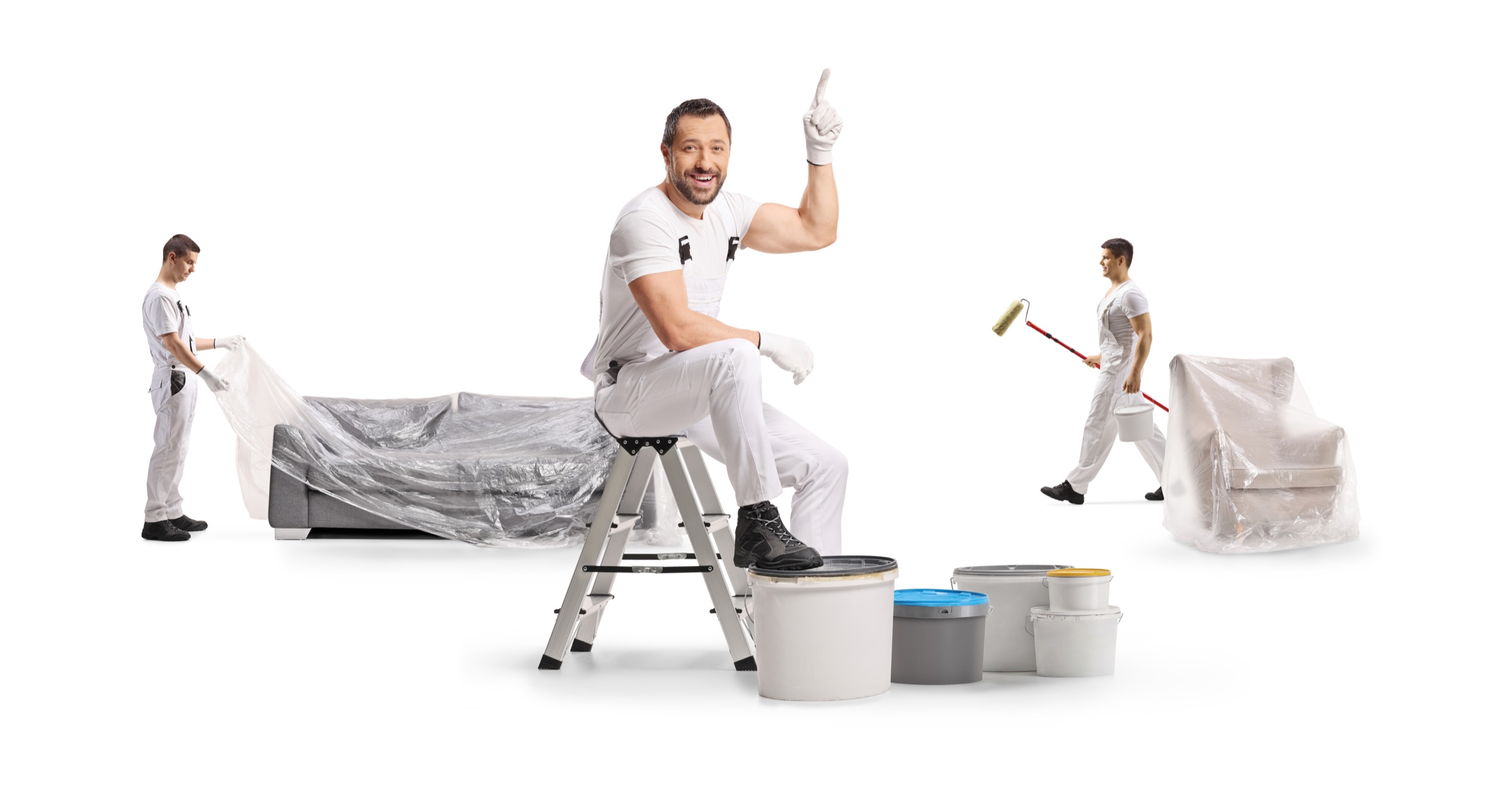 Professional painters carefully covering furniture before painting